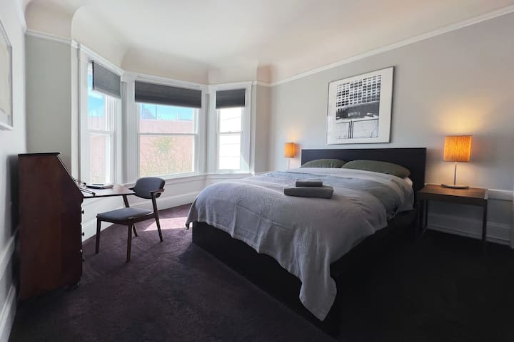 Quiet bedroom I with a queen bed, closet space and a small desk