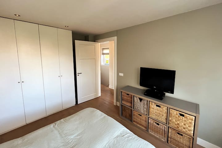 Dormitorio 2 en el segundo piso con cama tamaño king. Brand Auping con hermosos colchones, un extremo principal y pies ajustables elásticamente.

Detrás de la puerta hay un bar donde puedes colgar tu ropa. 