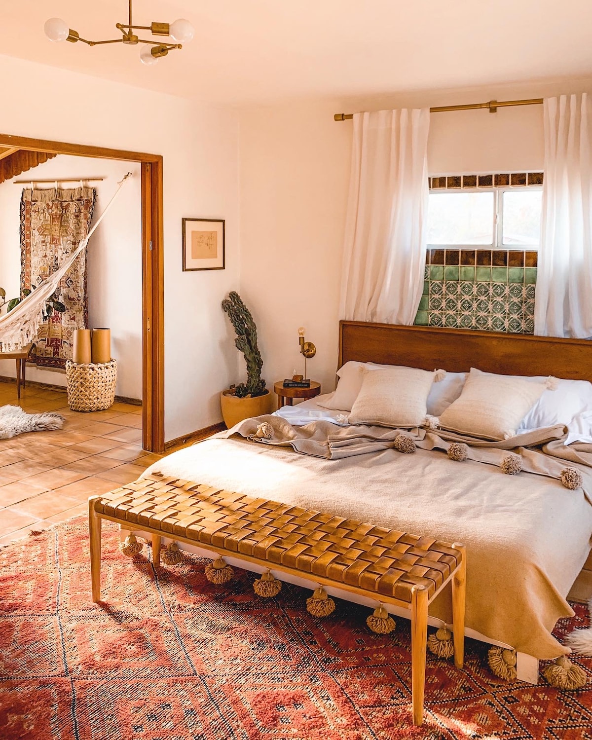 Primary Bedroom with a king sized bed, eastern facing windows with attached an yoga/ hammock room and private bathroom.