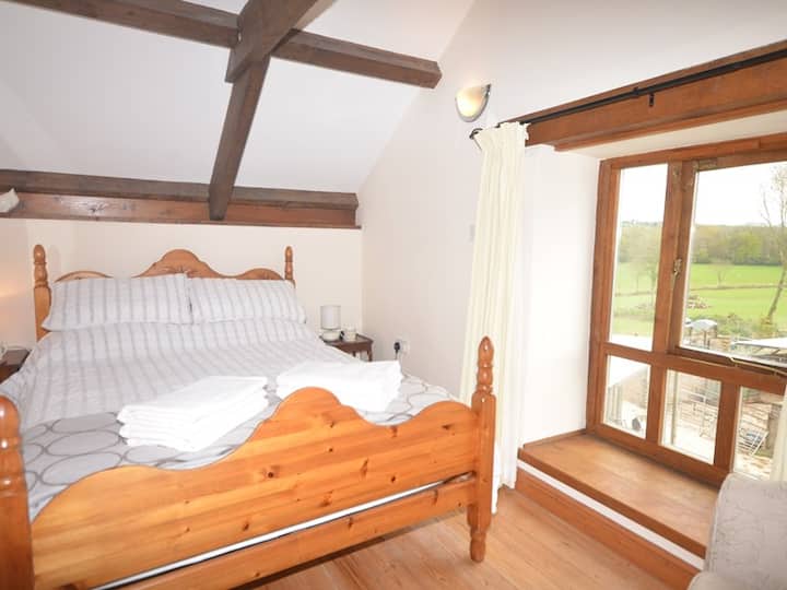 Double bedroom with views over the farmyard, fields and beyond