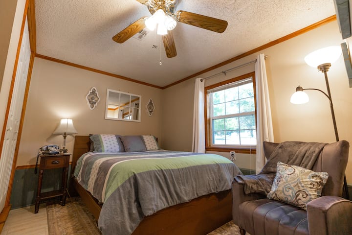 Downstairs Queen Bedroom. View to the east toward front entrance and the spacious yard where the fire pit is located.