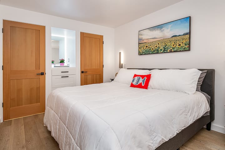 Bedroom one has oak engineered floors, a king sized bed, and lots of storage space.