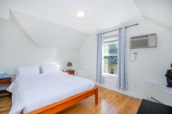 Druhá spálňa s manželskou posteľou Queen, sochou a ďalšími umeleckými dielami, organickým matracom a východným oknom