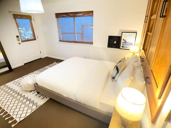 Bedroom 1—each bedroom is generously sized with a queen bed and storage