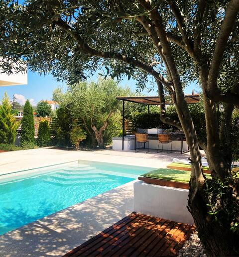 Modern house with private yard and heated pool.