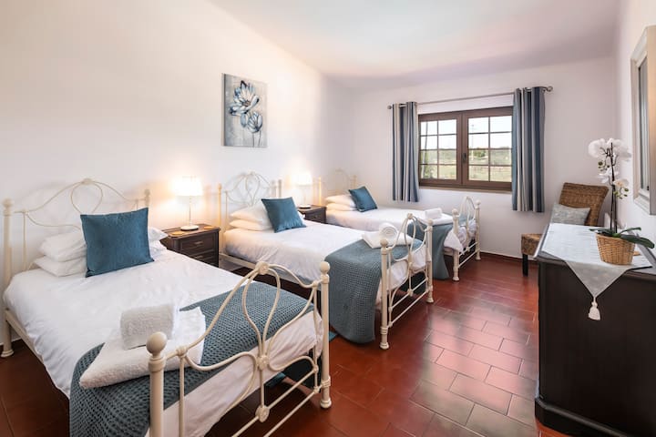 2nd Bedroom with 3 single beds and ensuite shower room (overlooking the pool - north facing so keeps cool in summer). Bedside drawers with table lamps, wardrobe and chest drawers.  