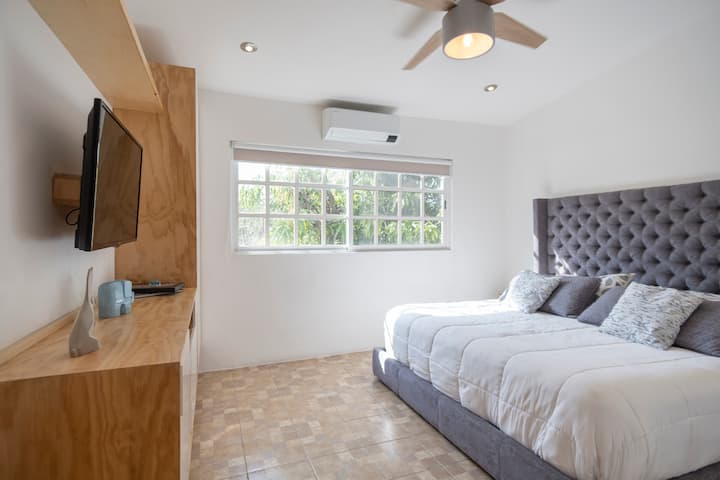 Bedroom with king-size bed upstairs, includes TV and air conditioning