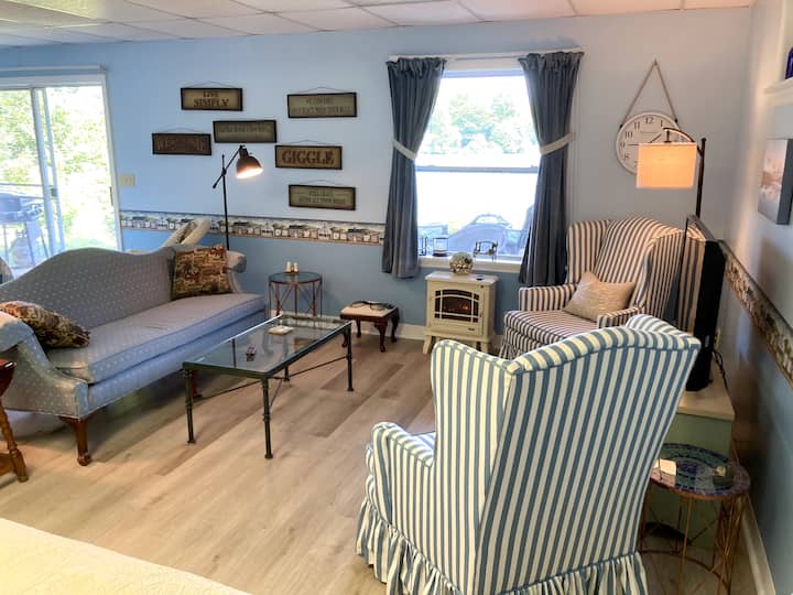 พื้นที่นั่งเล่นที่อบอุ่นพร้อมวิวน้ำโคมไฟอ่านหนังสือที่ดีและเตาผิงไฟฟ้า