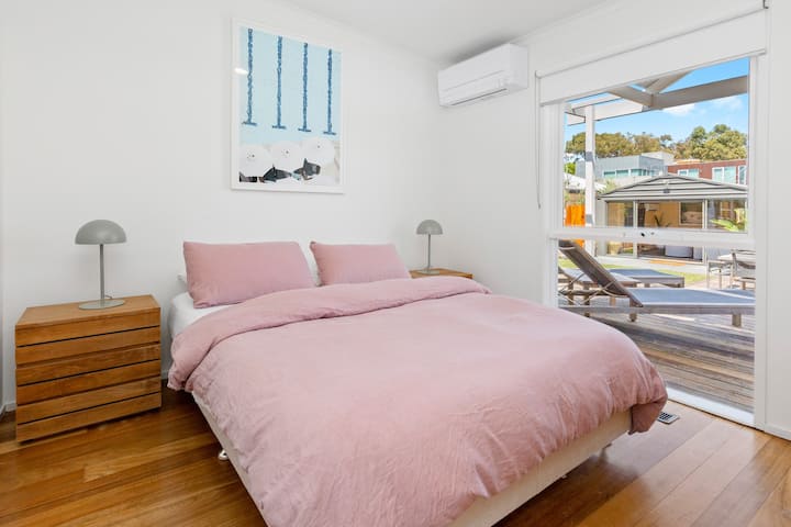 Second main bedroom, has aircon and smart TV mounted on wall, Queen sized bed
