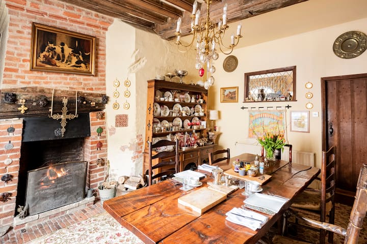 The oldest part of the house dating back to 1485. The fire place cut into the medieval brick staircase. Our ancient dresser has a wonderful
Collection of coloured glass & silver. Some believe that cuts in the brick are where swords were sharpened.