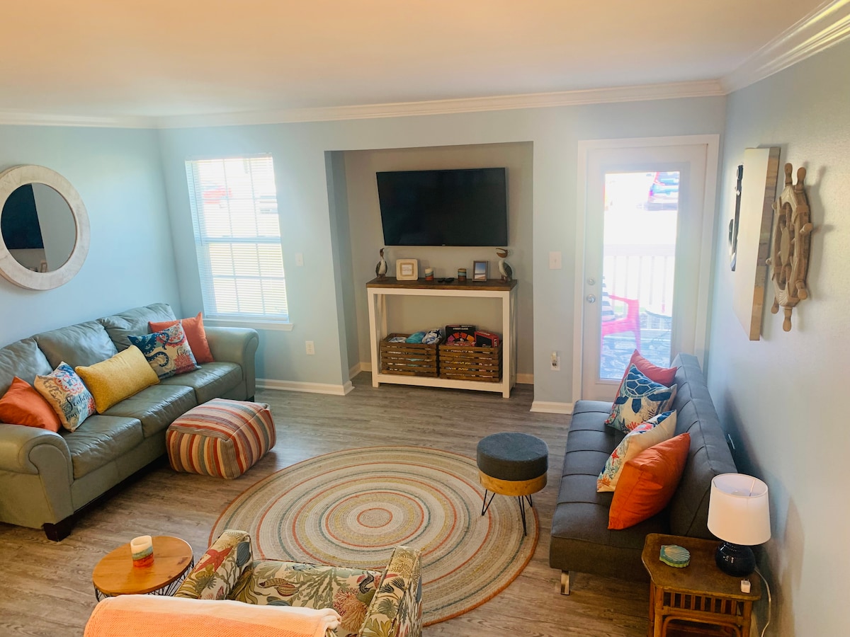 Brightly-lit living room area.