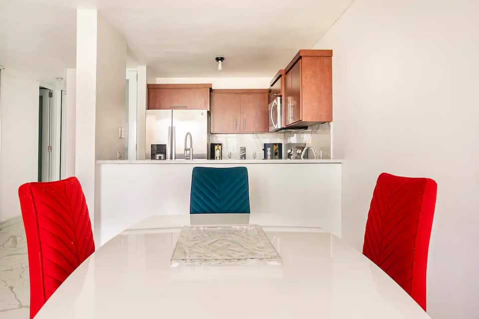 Condo dining table with the kitchen beyond