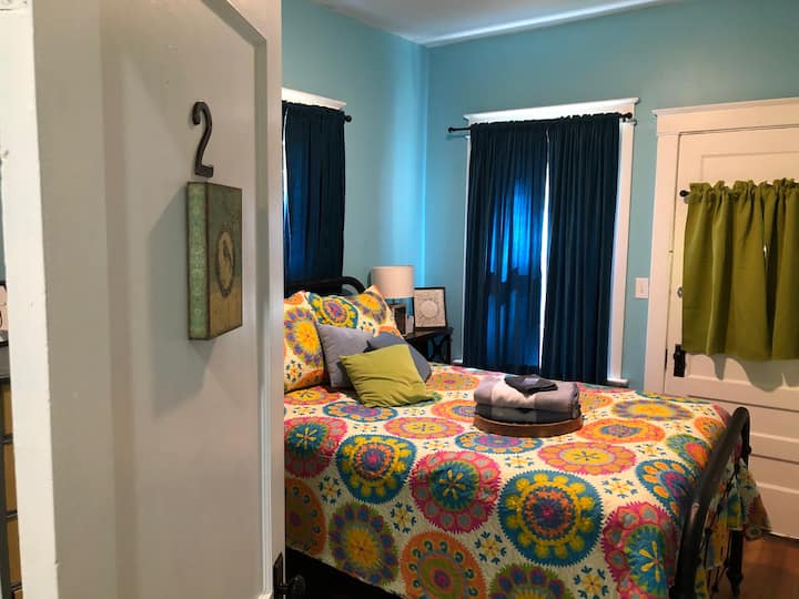 Bedroom 2 has a full-size bed with an antique iron bed frame. The mattress is incredibly comfortable and guests have described it as being "the best night's sleep [they] have ever had." There is also an alarm clock with USB chargers.