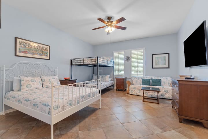 This Master bedroom en-suite sleeps 8.  3 Queen beds with a Queen sofa sleeper.  Plenty of space for larger family vacations.  65" Smart TV with cable included.  Bahama Shutters.