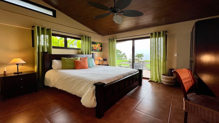 Second bedroom is spacious and colorful with same amenities as the master ... King-pillowtop bed with dressers and a wardrobe, desk area and access to the pool.  2nd bathroom is right around the corner. 