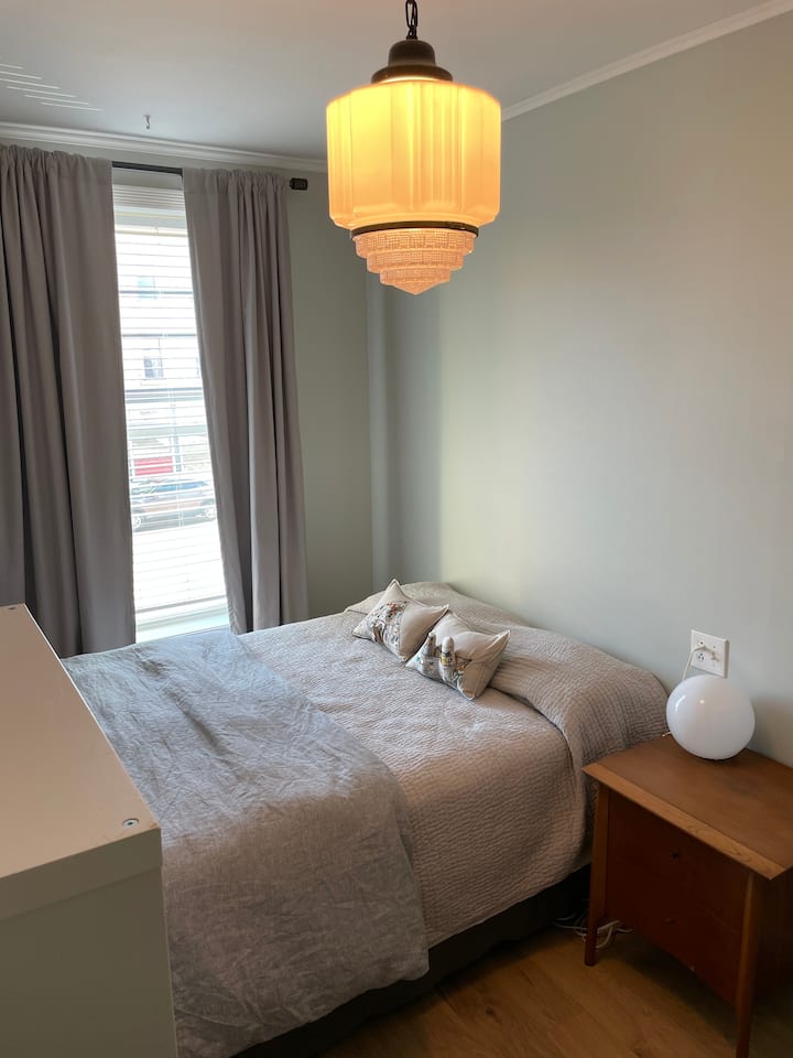 The second bedroom features a queen bed. In the summertime a window AC unit is installed which has the added bonus of blocking out any street noise. ***Please note that you have to walk through the main bedroom to get to the kitchen/living area.*** 