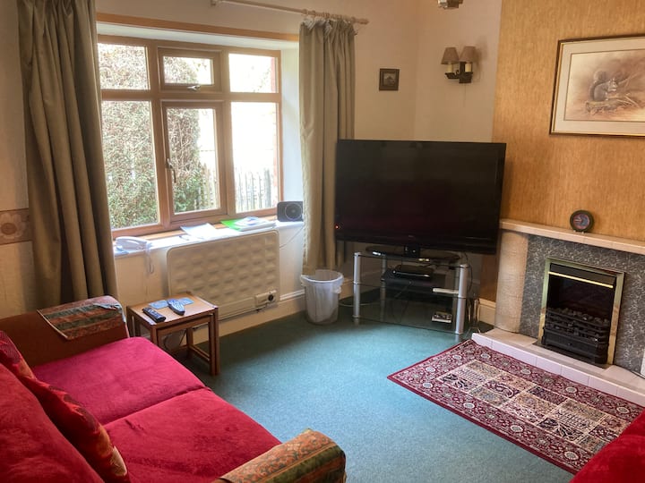 Lounge with view of front garden and oak woodlands