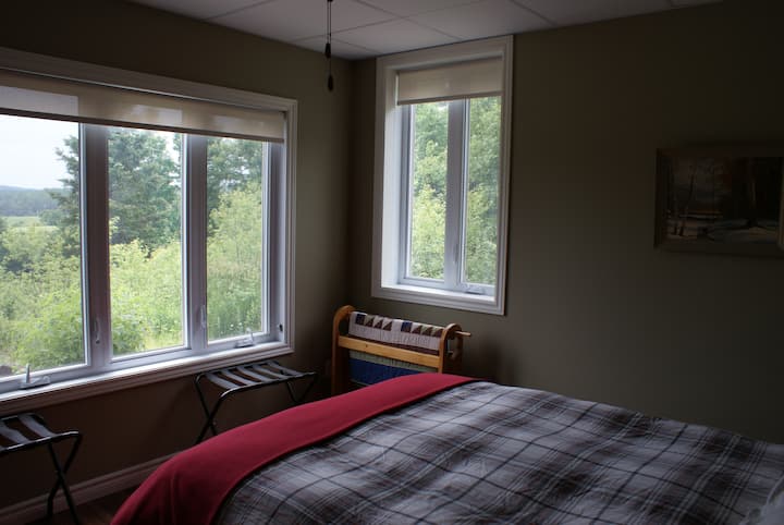 Primary guest room with queen bed