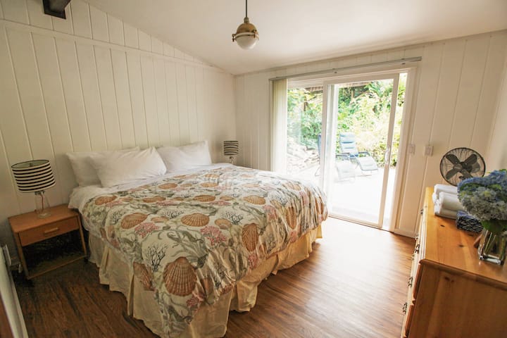 Bedroom 1 full renovation July 2021, with King Bed and direct access to back porch.