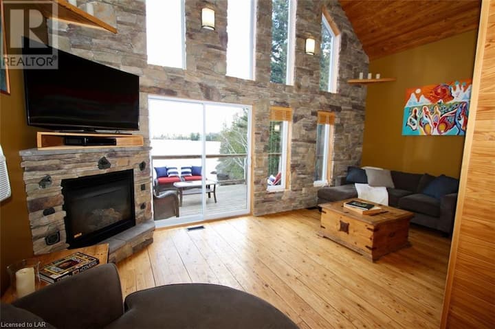 Main floor living room with fireplace and views of the lake.