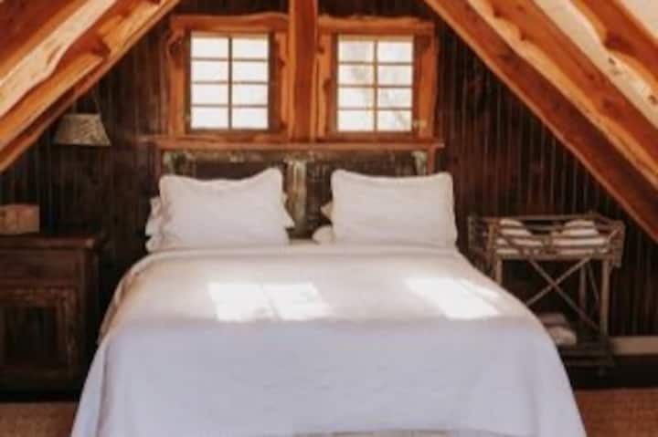 Upstairs in cabin #2, you will find Bedroom #4 with its own queen bed and private entrance. Downstairs is our silo bathroom with toilet, shower, full sink area. 
