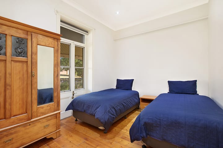 Bedroom with two king sized single beds on the raised ground floor.