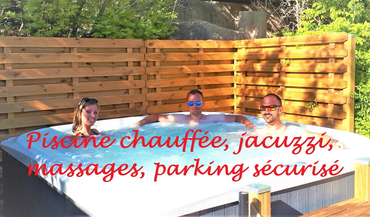 A private jacuzzi is surrounded by wooden paneling and lush greenery. The relaxing water invites guests to unwind. Sunlight filters through the trees, creating a serene atmosphere. The setting emphasizes privacy and comfort, ideal for restful moments.