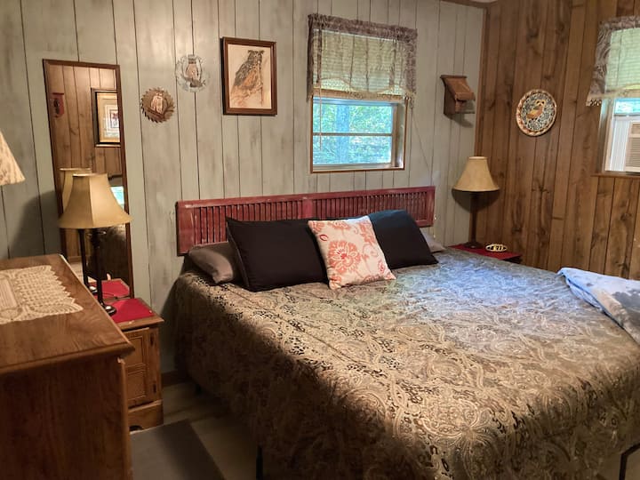 Main Bedroom - full king bed with new mattress. In the winter we have a small heater that warms the room wonderfully. In the warmer weather there is a window a/c unit plus ceiling fan to keep you cool.