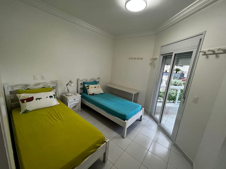 This is the upper room with two single beds. It has exit to the balcony and air condition.