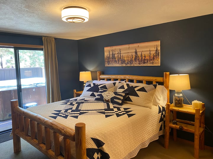 Primary bedroom with king sized bed and private hot tub area access from glass slider (or from porch)