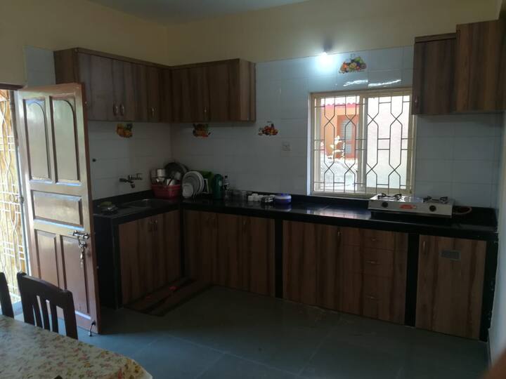 Kitchen Area with basic cooking Utilities, Fridge,Gas Stove, plates etc