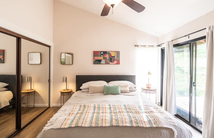 master bedroom with king bed and plush bedding