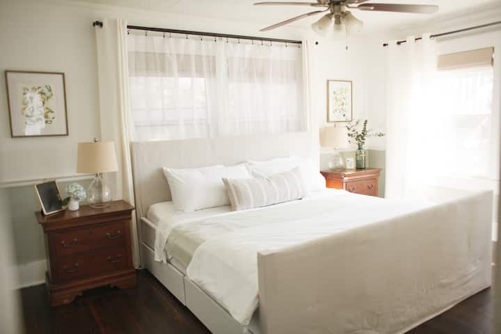 A beautifully lit room featuring a king-size bed. Ceiling fan, sunshade, linen.