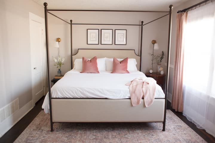 Light-filled primary bedroom with blackout shades. Spacious and relaxing! This has a Queen Bed.