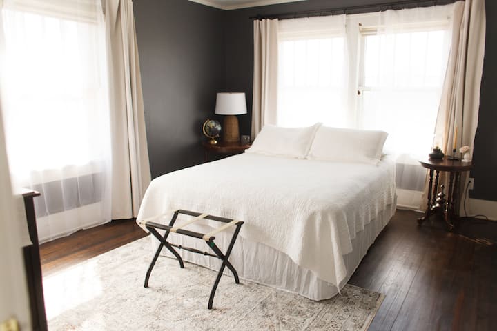 Light-filled upstairs bedroom with blackout curtains for those who like to sleep in :)