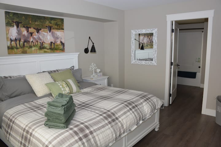View of master bedroom; king bed with ensuite access to bathroom