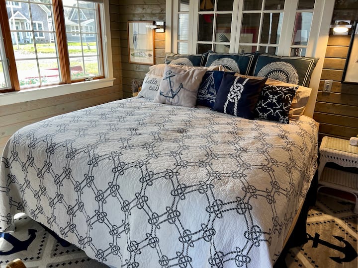 Watch the sun rise over the Chesapeake Bay from your spacious king-size bed. the vintage window at the head of the bed can be closed for privacy or opened for cross breezes from the Bay. 
This room is connected to the room with the day bed.