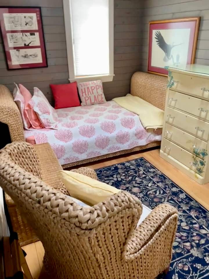 The twin size daybed is just right for reading by day, and sleeping at night. An antique window between the bedrooms can be closed for privacy, or opened to allow the bay breeze to waft through.
It is connected to the bedroom with the king size bed. 