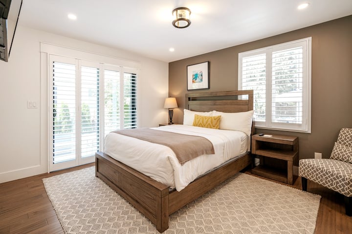 Guest bedroom with custom Queen size orthopaedic mattress, full ensuite w/ shower, ROKU TV, bedside lighting, hotel linens, standing oscillating fan, smart bed hook ups, walk in closet, California shutters and balcony doors with direct outside access