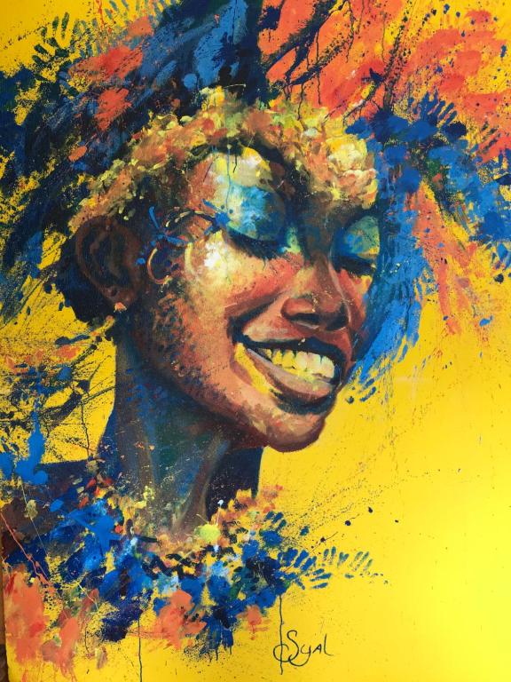 An abstract portrait artwork is displayed, featuring vibrant colors like blue, orange, and yellow. A stylized representation of a face is surrounded by splashes and handprints, creating a lively and dynamic visual effect against a bright yellow background.