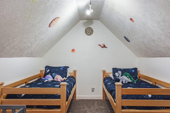 The bonus bedroom located off of the upper-level master bedroom has a fun "outer space" theme! We call it the SPACE ROOM, featuring two twins and a baby crib.
