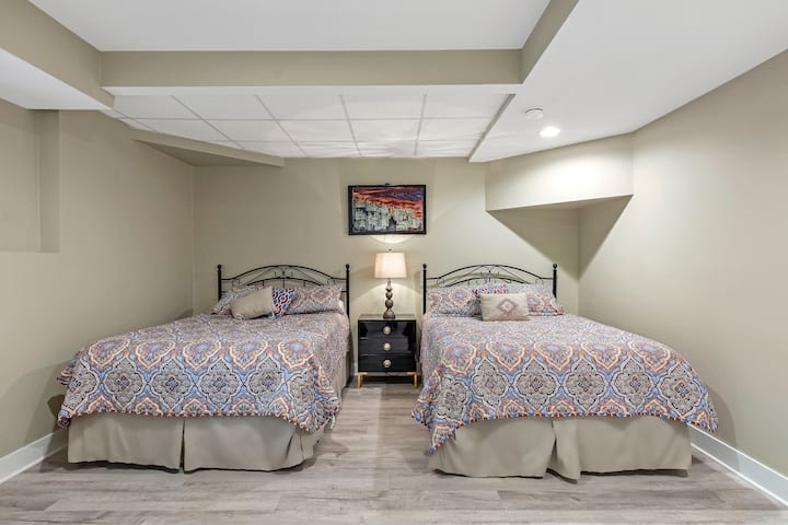 Lower level double queen bedroom is steps away from walkout to waterfall with koi fish