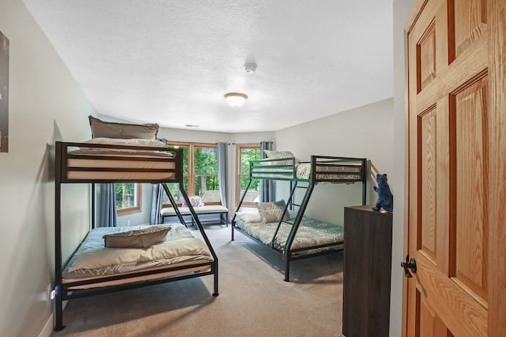 The upper level "slumber party" room features two twin over full bunks, walk-in closet, and a magnificent view of the ponds and pool