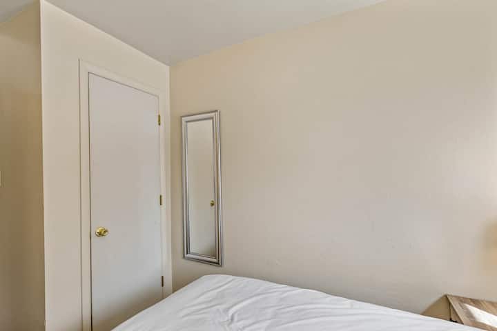 Downstairs bedroom with a queen bed. 