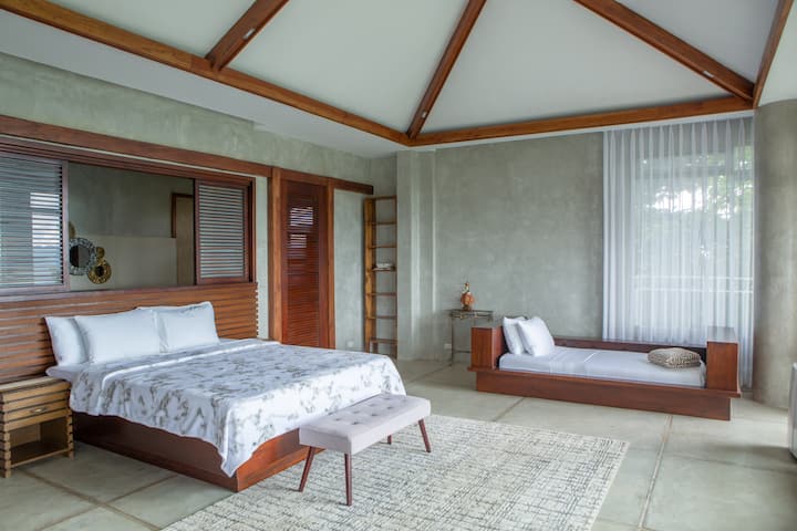 The primary bedroom with a king bed and a single. Additional beds are available upon request.