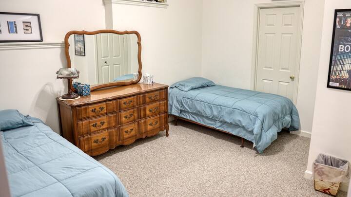 Second bedroom has two twin beds, a dresser with mirror, and a closet.