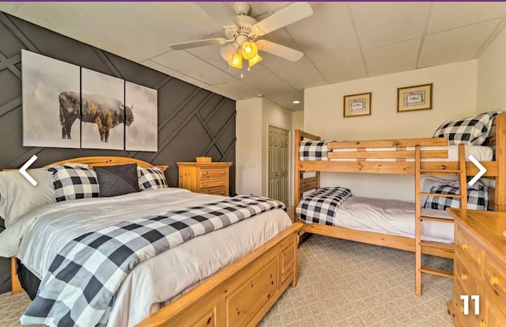 Downstairs bedroom with queen bed and twin bunk beds