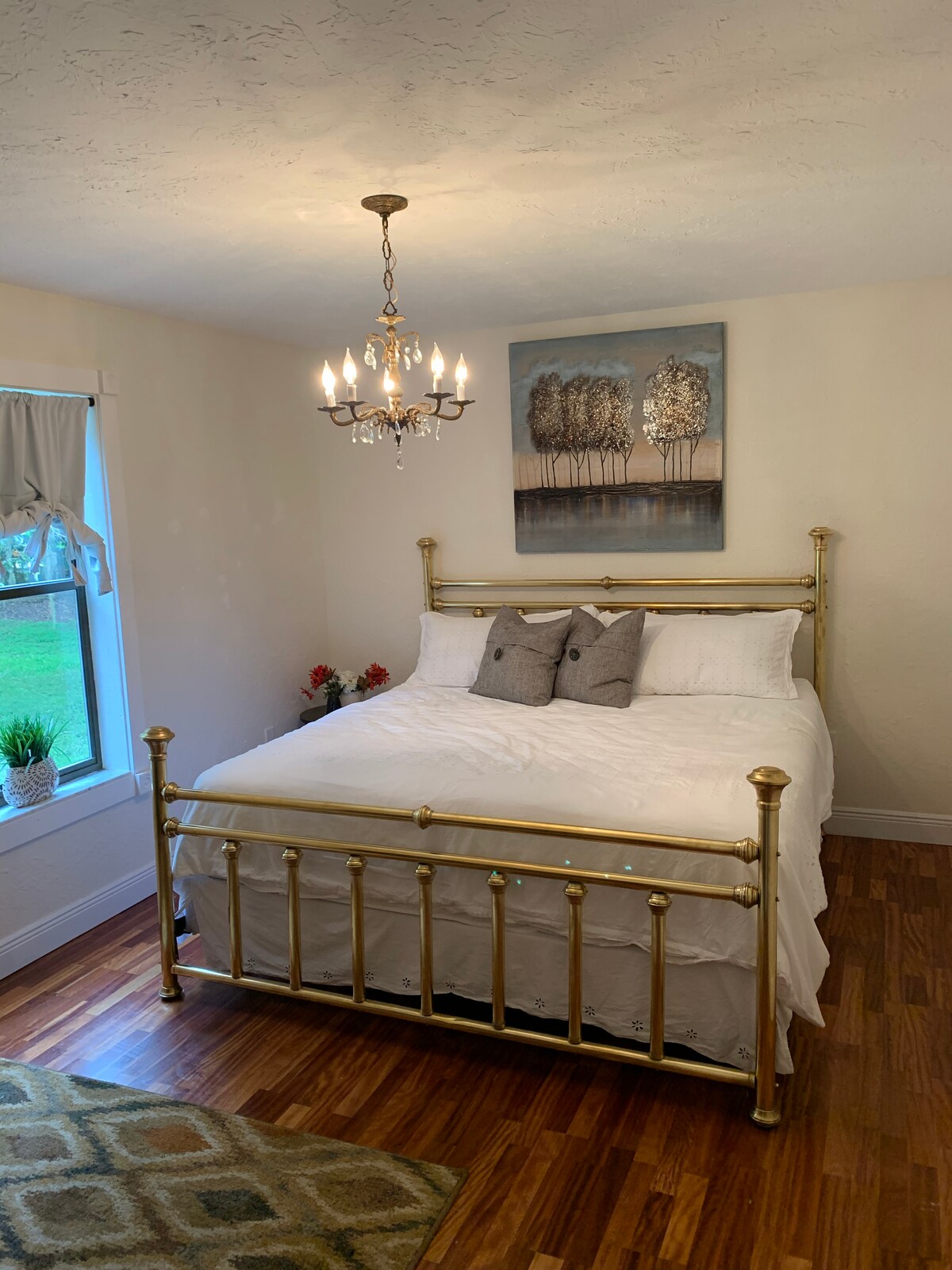 Brass king bedroom with electric fire place.