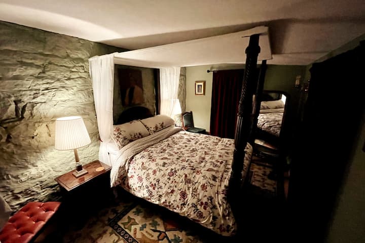 The main bedroom - an antique four poster bed with 1820s Victorian and Albert Museum bedding 