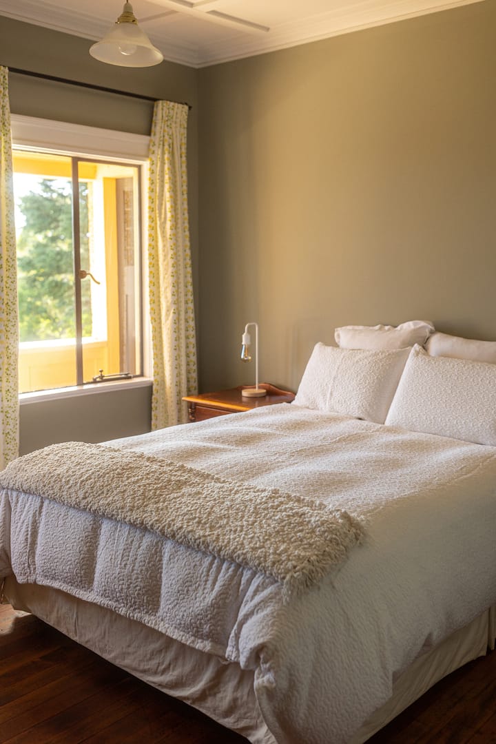 Queen bedroom opening out onto main balcony